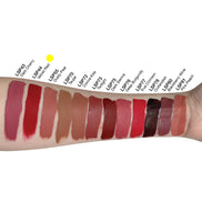 Matte Lip Stain in Velvet Red swatched on skin with other shades displayed