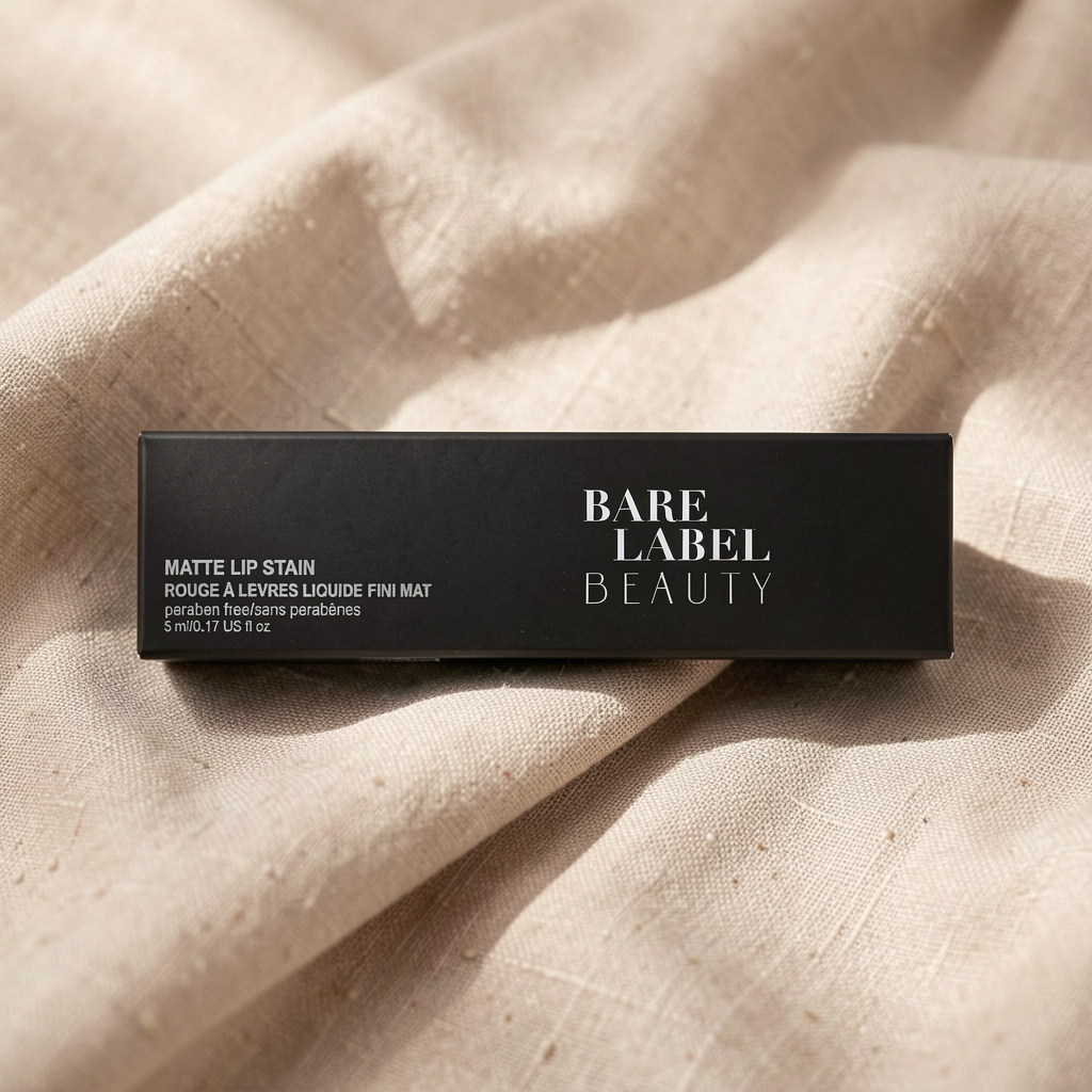 Matte Lip Stain in Velvet Red – black rectangular tube on beige linen flat lay